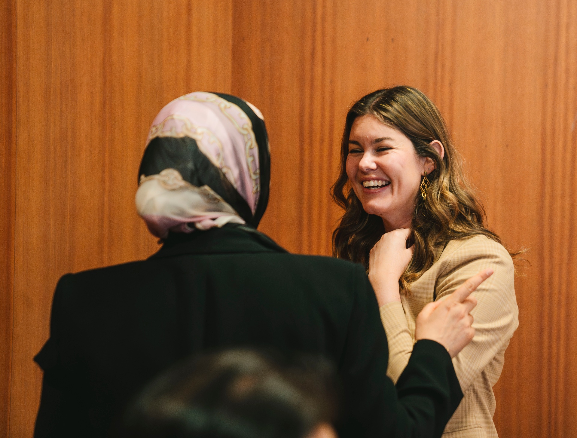 Two mentees sharing a laugh during the Madrid gathering