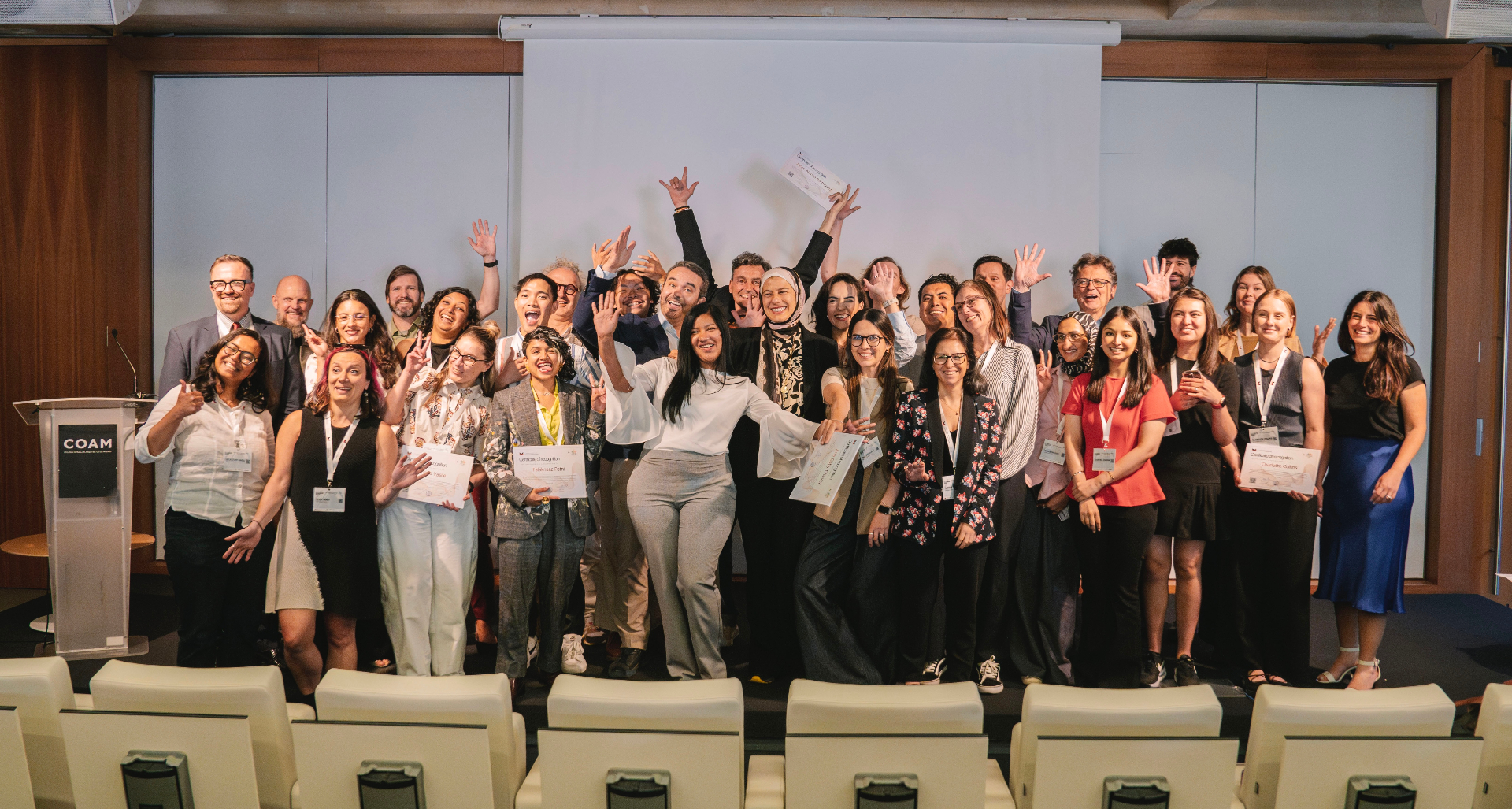 First edition mentees celebrating with their certificates at COAM, Madrid